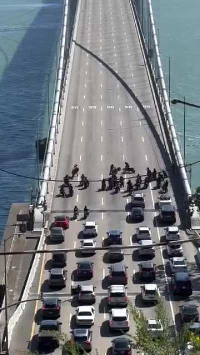 Blocking traffic on a bridge to do stunts 