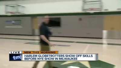 Landing a one-handed backwards half-court shot while conducting an interview on live TV... 