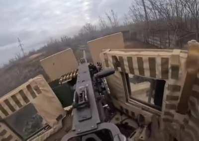 Ukrainian soldiers using a US-supplied MaxxPro MRAP to fire on Russian troops near the coke plant in Avdiivka 