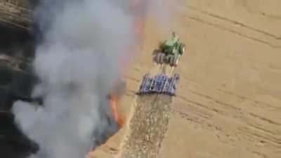 Farmer protecting his farm from fire.