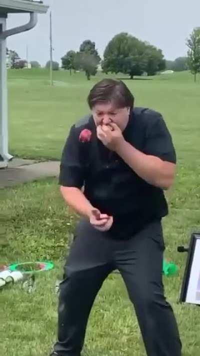 A man juggling and eating at the same time