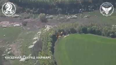 Drone footage of a Russian D-30 122-mm towed howitzer with ammunition getting hit by a Ukrainian missile fired from an M-142 HIMARS.