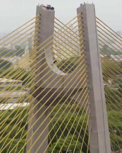 Pro skater Sandro Días skating on one of the highest bridges in São Paulo