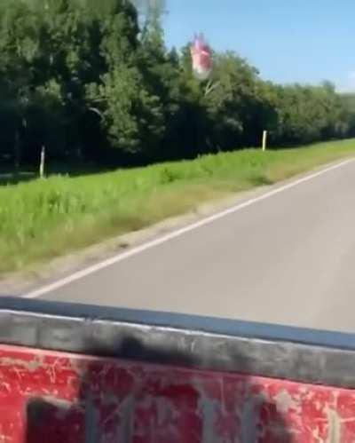 Empty bottle being dragged along a car by aerodynamic drag