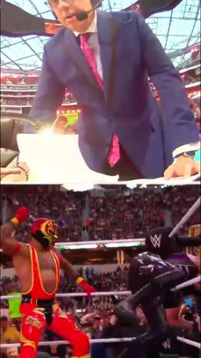 Michael Cole gets up on his feet as Rey starts whipping his son at Wrestlemania