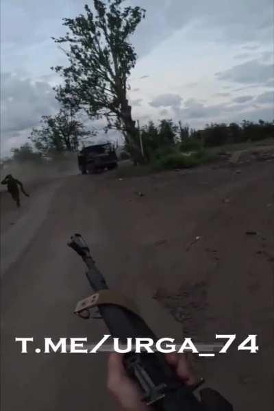 Russian soldiers GoPro films a Ukranian FPV drone barely missing their truck, the soldiers get out fearing a second attack but then continue driving