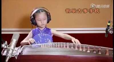 6 year old playing the Koto with the arm moves and posture of someone playing from the 1800s.