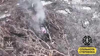 Two Russian soldiers in an embrace, are hit by drop dropped grenade