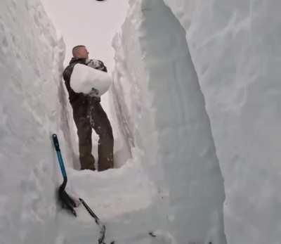 Building snow shelter during snow storm