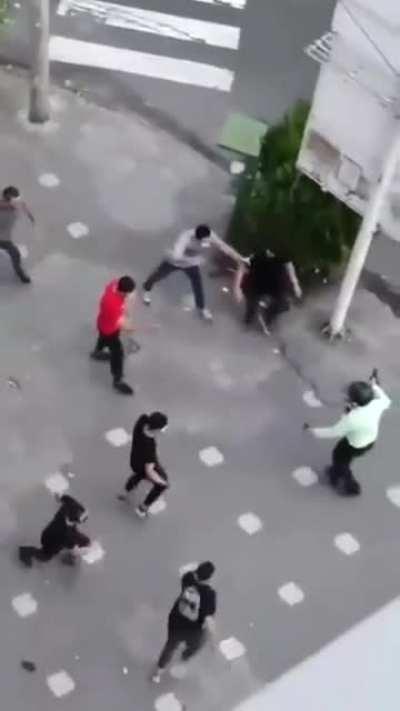 people attacking a police in a protest in Iran