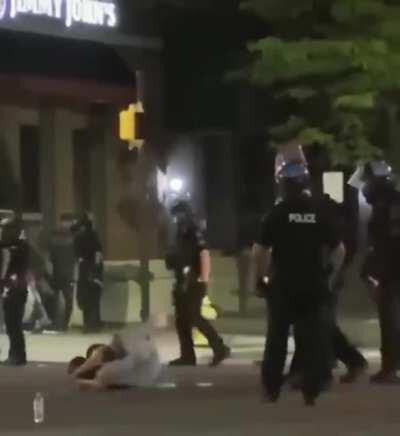 Police officers pepper spray 15 year old girl and kick her in the face as she sits blinded, motionless and threatening nobody