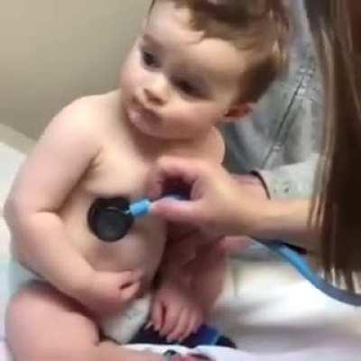 Baby rests head on nurse's hand