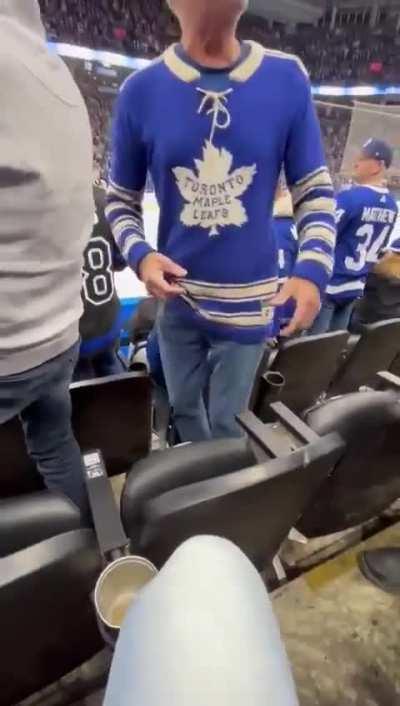 Leafs fan throws another fans expensive hat on the ice