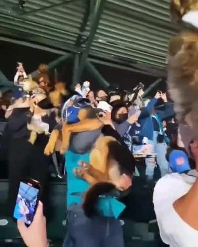 Fans at the Mariners' game brought their dogs to the ball park to hold up their dog for the chance to be featured on the Simbacam