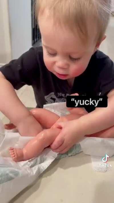 Toddler changes her first diaper!