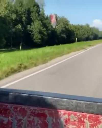 Turbulence at work: turbulent flow behind a moving car keeps a plastic bottle from falling down