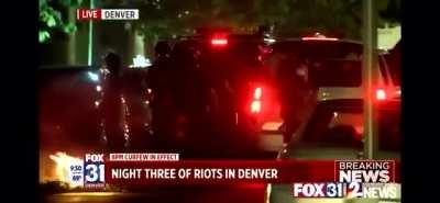 Denver police seen pushing a reporter into a fire