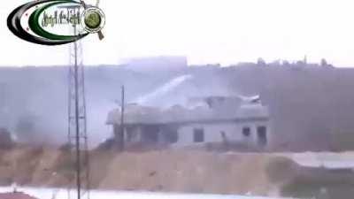 FSA fighters engage a sandbagged Syrian Army checkpoint with high-caliber technical fire before the arrival of an T-72 forces a change of position - Atshan - 2012