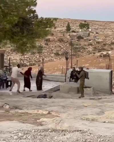 Israeli settlers attacking Palestinians while being defended by IDF