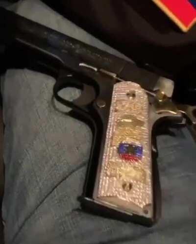 One of El Ruso’s men shows off his custom pistol