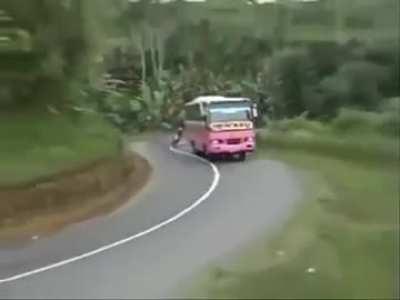 biker overtaking a bus