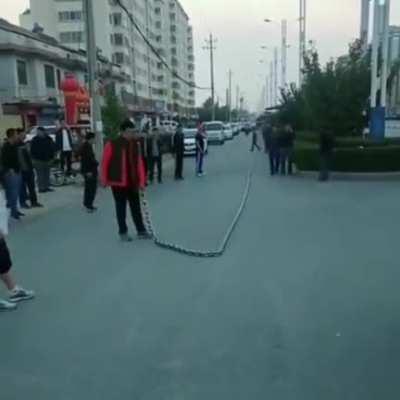 Guy whipping a giant chain