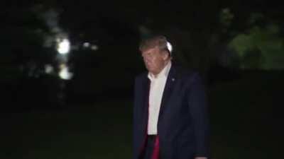 Trump Walks Along Darkened Corridors