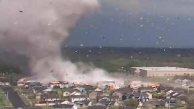 Drone footage of a tornado devastating a neighborhood