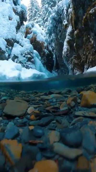 🔥 Snow flakes fall softly into crystal clear water ❄️