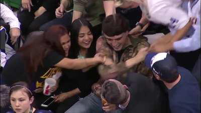 Kobe tosses his sleeve to a fan, and another fan steals it.