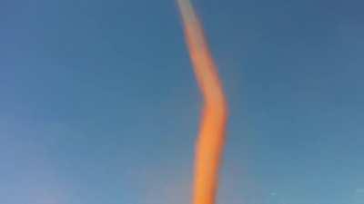 The interesting color of this large dust devil!