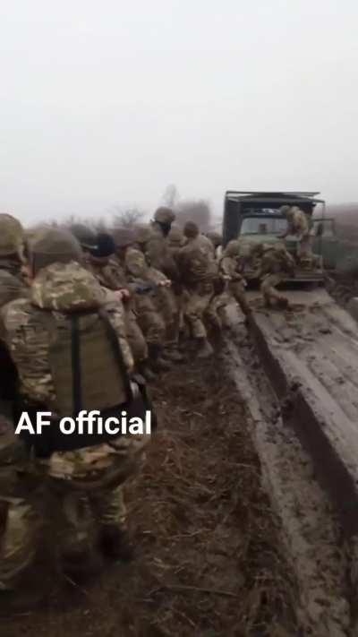 Ukrainian soldiers prepare to pull their transport out of the mud: When you don't have a recovery vehicle, but the truck is full of men, this is a good way to get unstuck!