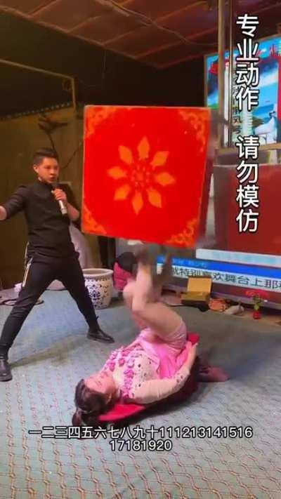 Woman rotating a pot and table with her feet