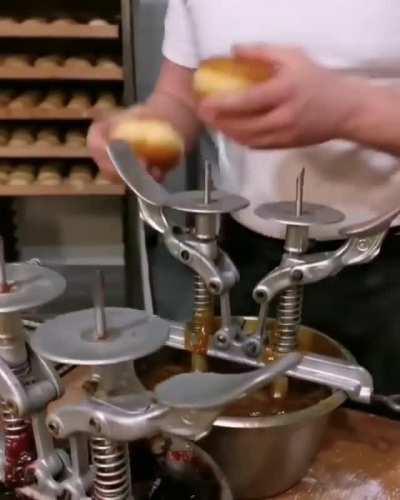 This man is filling donuts like it's his job. Because it is