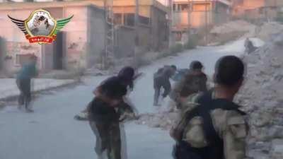 A large group of Liwa al-Tawhid fighters suppress while setting up an improvised rocket during fighting in Aleppo - 6/20/2013