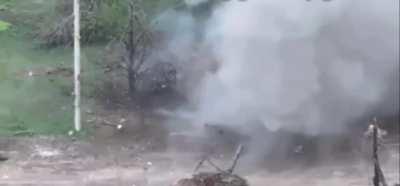 2 russian soldiers attempt to pick up a mine causing it to detonate.