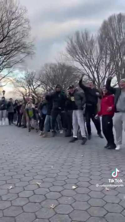 A group of guys walking through the park, encountering this random skater, and hyping him up