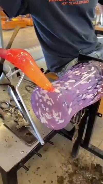 Blowing glass to make a vase