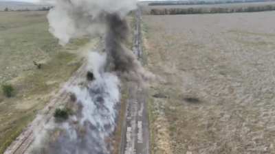 A Ukrainian drone operator uses an explosive charge hanging from his drone to clear a Russian mine barrier.