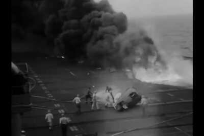 Commander George C Duncan is pulled out alive from the cockpit of his Grumman F9f Panther after crashing during an attempted landing on USS Midway on July 23rd 1951