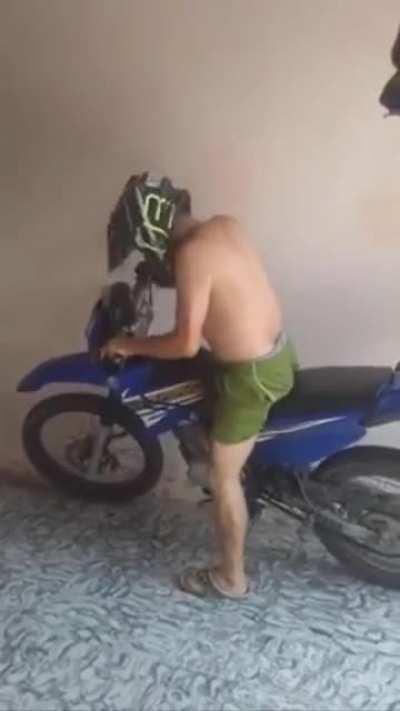 Dude is having a problem starting his motorbike.