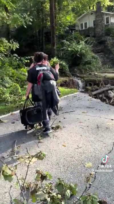 Residents of Chimney Rock, NC are forced to pack supplies on their backs and hike out of town to emergency services after 3 days without help 