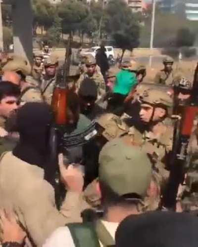 The Lebanese army standing infront of a group of armed protestors