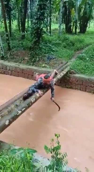 People go fishing in canals. This guy is fishing for coconuts!