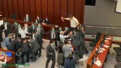 Hong Kong security forcibly removes Democratic council and then unanimously votes pro-Communist as new chairman.