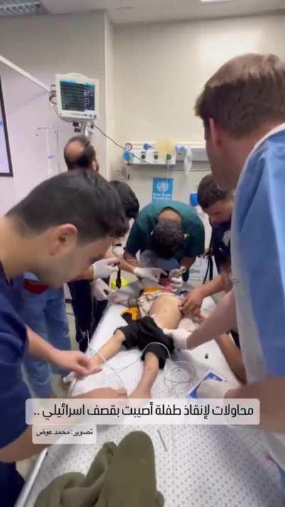 Doctors trying to save a girl injured in the israeli occupation's airstrikes on the Gaza Strip