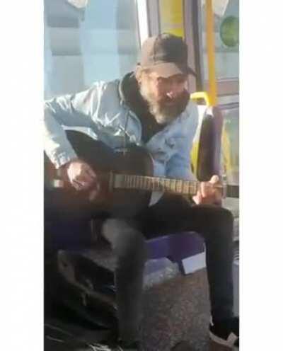 Irish street performer sings 'You've Got a Friend In Me' to an autistic child on public transport.