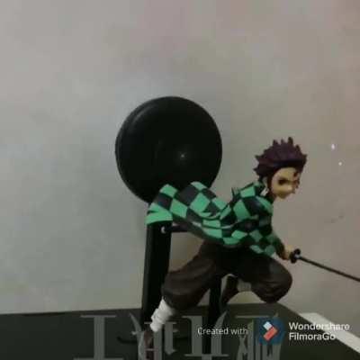 This demon slayer figure has an animation background