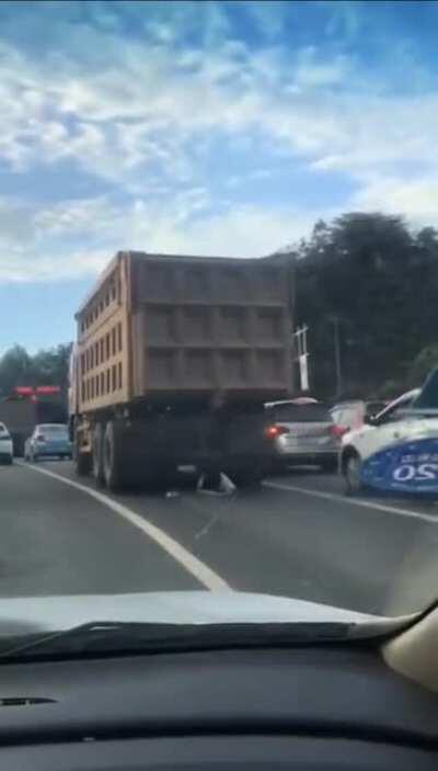 Woman almost gets crushed by a truck