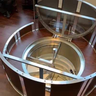 Spiral wine cellar with an automated handrail and safety barricade.